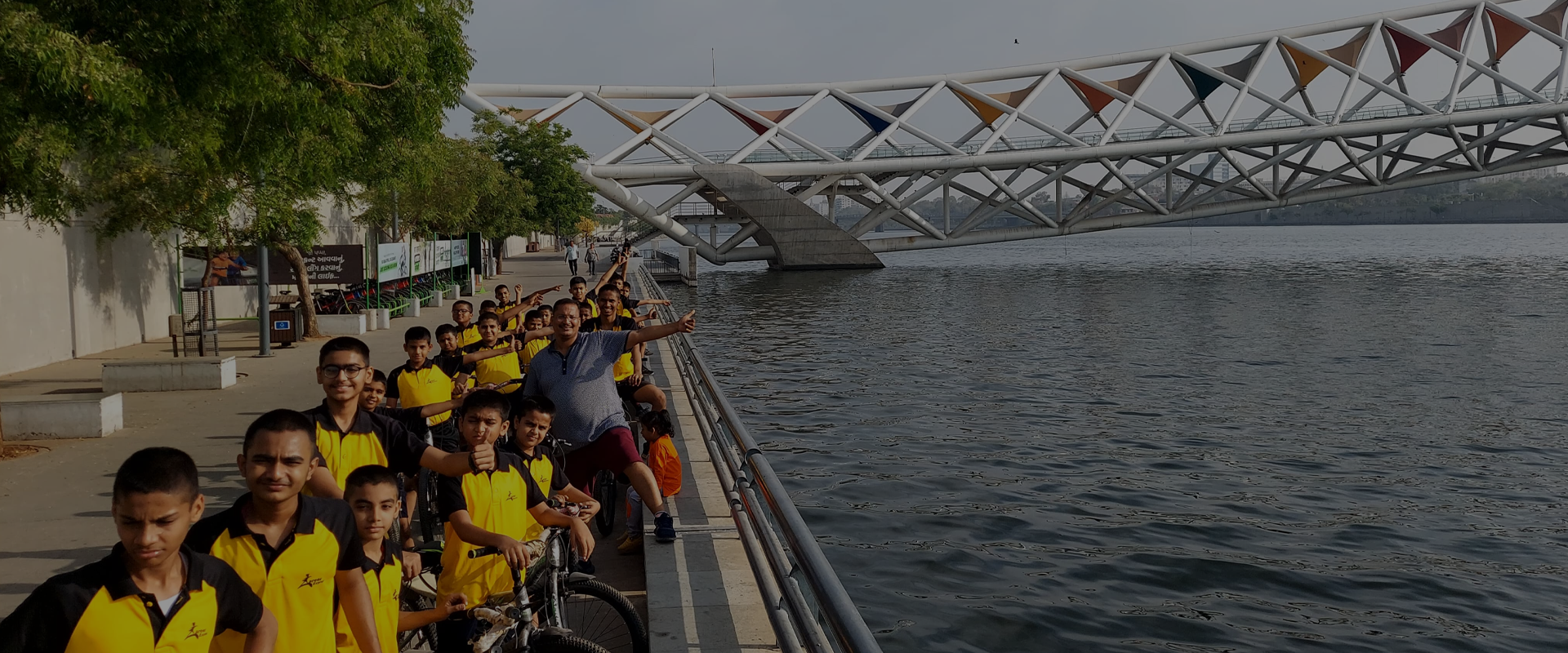 Career Express students cycling beside the riverfront in Ahmedabad